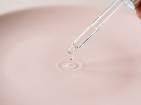 Niacinamide serum drop from a glass dropper